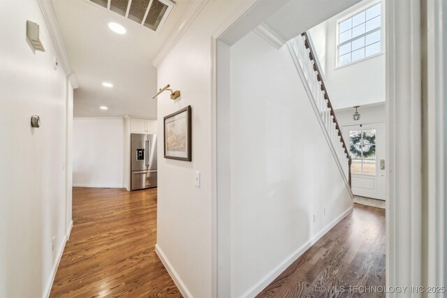 11818 N Harvard Ave, Skiatook, OK 74070 - hallway featuring stairs, wood finished floors, crown molding, baseboards, and recessed lighting