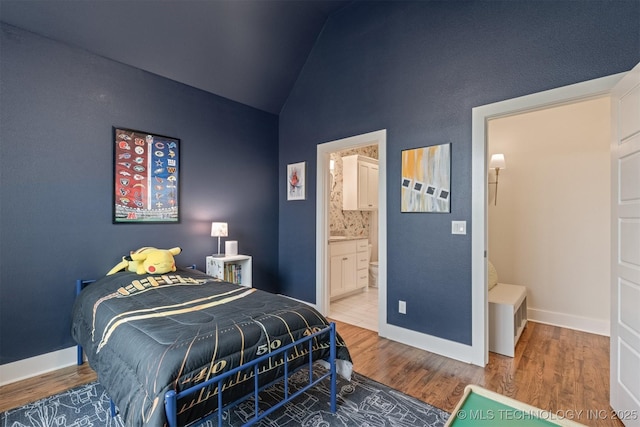 6705 S Palm Ave, Broken Arrow, OK 74011 - bedroom with wood finished floors, baseboards, connected bathroom, and high vaulted ceiling
