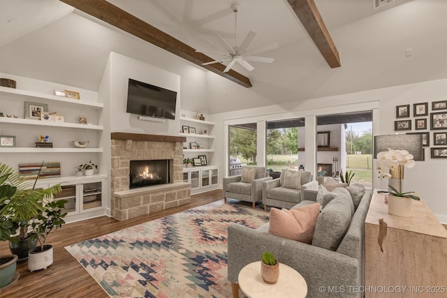 6705 S Palm Ave, Broken Arrow, OK 74011 - living room with a stone fireplace, a ceiling fan, beam ceiling, wood finished floors, and built in shelves