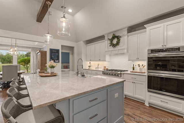 6705 S Palm Ave, Broken Arrow, OK 74011 - kitchen with appliances with stainless steel finishes, white cabinetry, high vaulted ceiling, dark wood-style floors, and light stone countertops