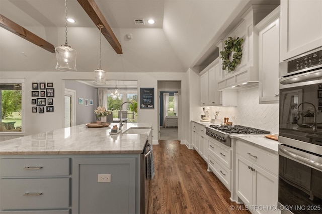 6705 S Palm Ave, Broken Arrow, OK 74011 - kitchen featuring appliances with stainless steel finishes, a kitchen island with sink, healthy amount of natural light, tasteful backsplash, and recessed lighting