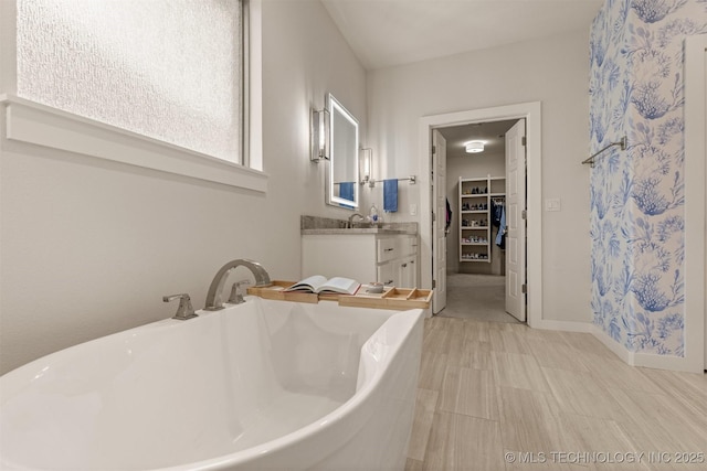 6705 S Palm Ave, Broken Arrow, OK 74011 - full bathroom featuring vanity, a spacious closet, a freestanding bath, curtained shower, and baseboards