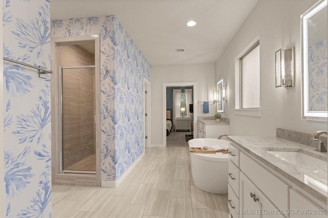 6705 S Palm Ave, Broken Arrow, OK 74011 - bathroom with a stall shower, two vanities, a soaking tub, wallpapered walls, and recessed lighting