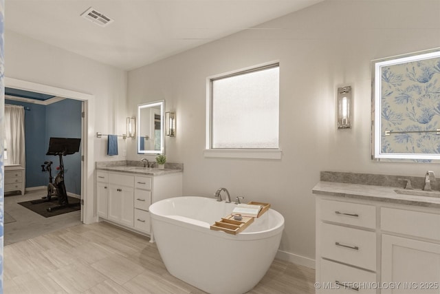 6705 S Palm Ave, Broken Arrow, OK 74011 - full bath featuring two vanities and a freestanding bath
