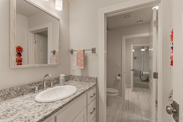 6705 S Palm Ave, Broken Arrow, OK 74011 - bathroom with toilet, vanity, marble look tile flooring, and a ceiling fan