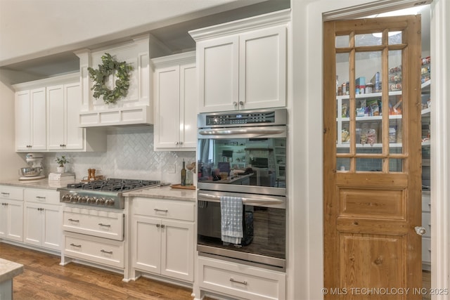 6705 S Palm Ave, Broken Arrow, OK 74011 - kitchen featuring appliances with stainless steel finishes, tasteful backsplash, white cabinets, and light stone countertops