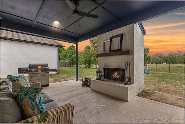 6705 S Palm Ave, Broken Arrow, OK 74011 - patio terrace at dusk with an outdoor brick fireplace, a ceiling fan, a patio area, and grilling area