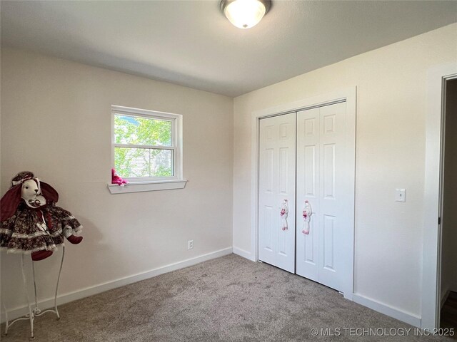 11522 E 64th St, Broken Arrow, OK 74012 - unfurnished bedroom featuring carpet flooring, baseboards, and a closet