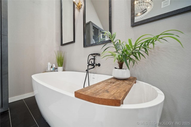 20119 E Willis Rd, Tahlequah, OK 74464 - bathroom with a freestanding tub, a chandelier, baseboards, and tile patterned floors
