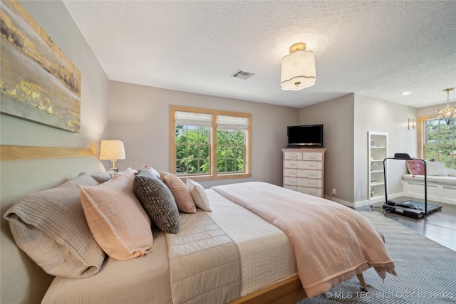 20119 E Willis Rd, Tahlequah, OK 74464 - bedroom with wood finished floors, a textured ceiling, and baseboards