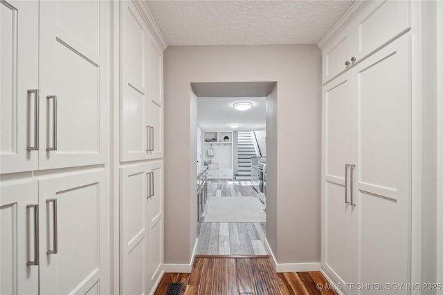 20119 E Willis Rd, Tahlequah, OK 74464 - hall with baseboards, wood finished floors, and a textured ceiling