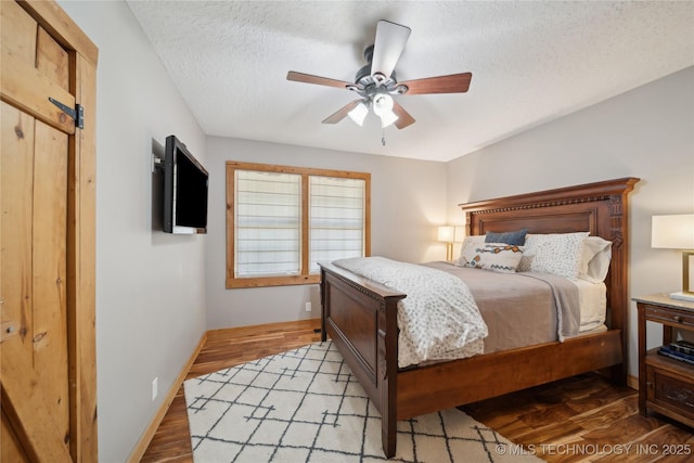 20119 E Willis Rd, Tahlequah, OK 74464 - bedroom featuring a textured ceiling, light wood-type flooring, baseboards, and a ceiling fan