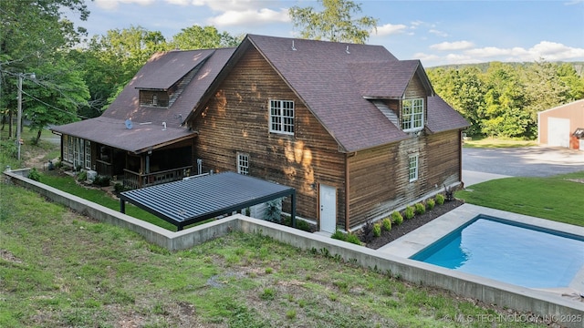 20119 E Willis Rd, Tahlequah, OK 74464 - rear view of house featuring an outdoor pool, roof with shingles, and a yard