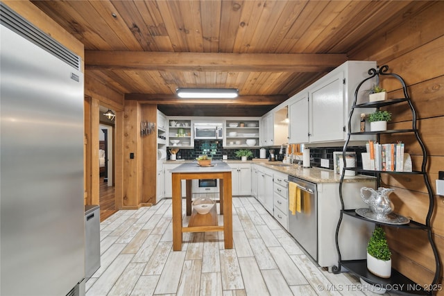20119 E Willis Rd, Tahlequah, OK 74464 - kitchen with open shelves, stainless steel appliances, decorative backsplash, wooden ceiling with exposed beams, and white cabinetry