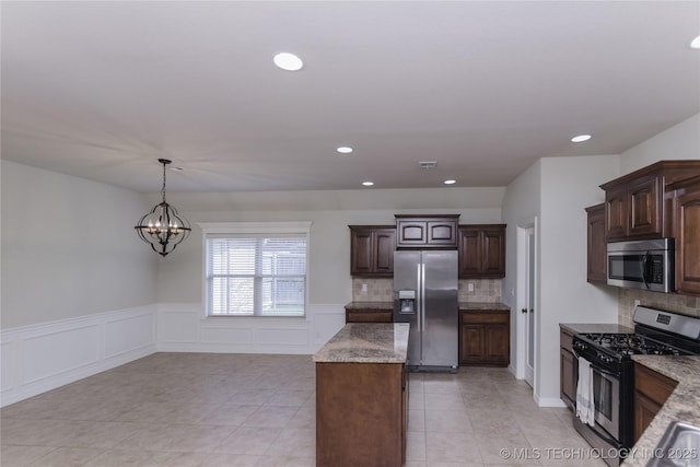 9241 N 144th E Ave, Owasso, OK 74055 - kitchen featuring stainless steel appliances, a kitchen island, tasteful backsplash, recessed lighting, and dark brown cabinetry
