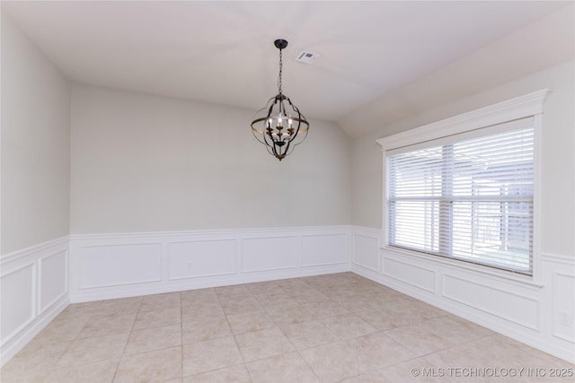 9241 N 144th E Ave, Owasso, OK 74055 - unfurnished room with a chandelier, a decorative wall, wainscoting, and light tile patterned flooring