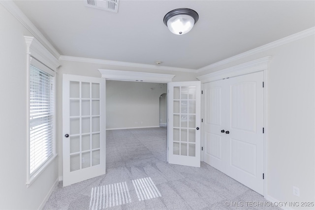 9241 N 144th E Ave, Owasso, OK 74055 - unfurnished bedroom featuring french doors, carpet floors, ornamental molding, a closet, and baseboards