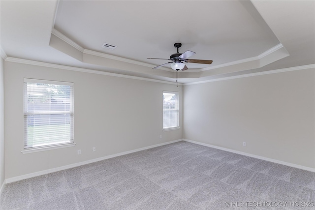 9241 N 144th E Ave, Owasso, OK 74055 - unfurnished room with a raised ceiling, healthy amount of natural light, ornamental molding, a ceiling fan, and carpet floors