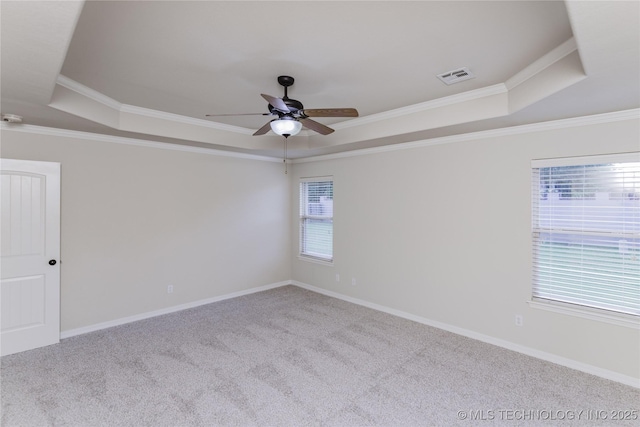 9241 N 144th E Ave, Owasso, OK 74055 - carpeted spare room featuring a tray ceiling, ceiling fan, ornamental molding, and baseboards