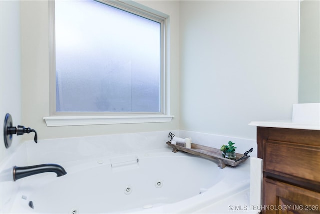 9241 N 144th E Ave, Owasso, OK 74055 - bathroom with a tub with jets and vanity