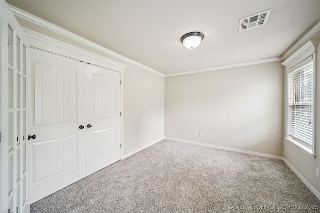 9241 N 144th E Ave, Owasso, OK 74055 - unfurnished bedroom with carpet, multiple windows, crown molding, and baseboards