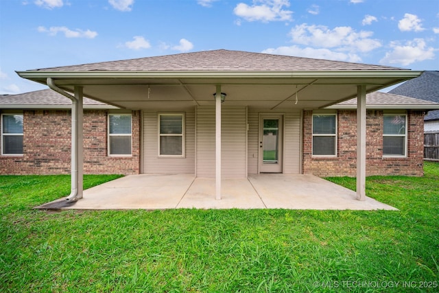 9241 N 144th E Ave, Owasso, OK 74055 - back of house with brick siding, a patio area, and a yard