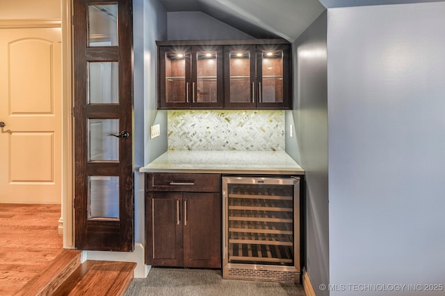 1412 E 37th St, Tulsa, OK 74105 - indoor dry bar featuring beverage cooler, decorative backsplash, vaulted ceiling, and wood finished floors