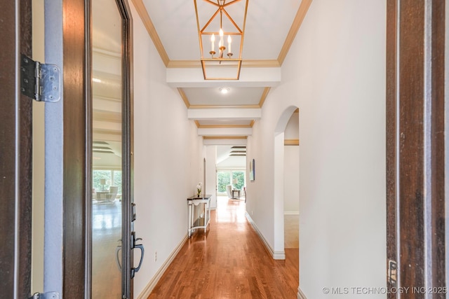 1412 E 37th St, Tulsa, OK 74105 - hallway featuring arched walkways, wood finished floors, ornamental molding, a chandelier, and baseboards