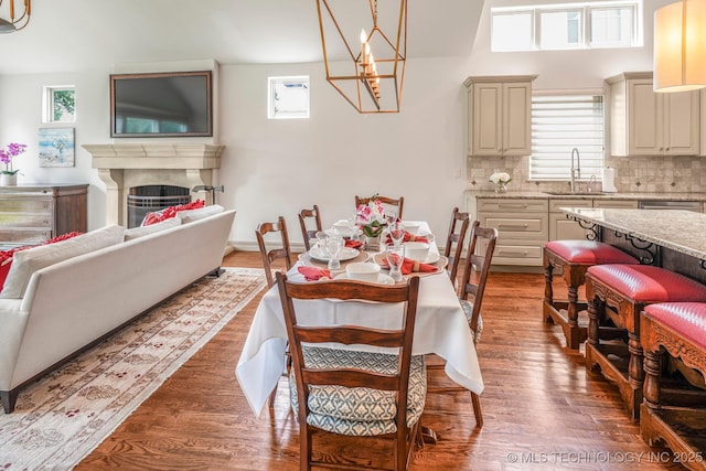 1412 E 37th St, Tulsa, OK 74105 - dining space featuring plenty of natural light, light wood finished floors, a fireplace, and a chandelier