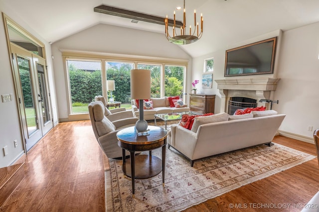 1412 E 37th St, Tulsa, OK 74105 - living room featuring lofted ceiling, a fireplace, wood finished floors, and baseboards
