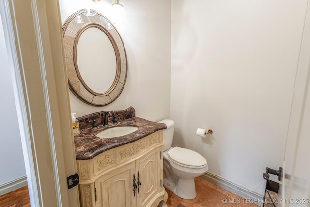 1412 E 37th St, Tulsa, OK 74105 - half bathroom with vanity, toilet, and baseboards