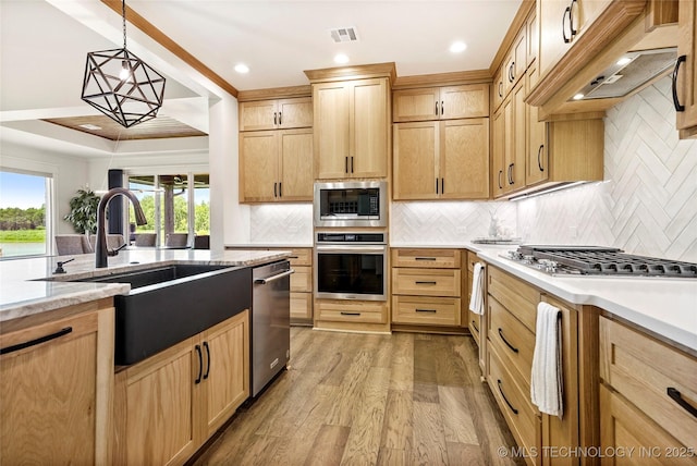 3406 W Quantico Pl, Broken Arrow, OK 74011 - kitchen with appliances with stainless steel finishes, light brown cabinetry, light wood finished floors, a sink, and recessed lighting