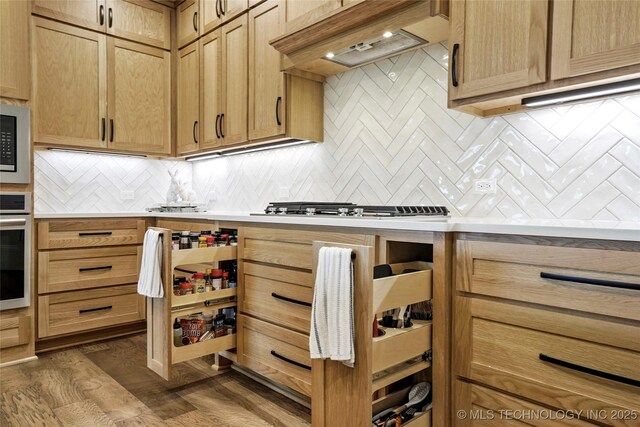 3406 W Quantico Pl, Broken Arrow, OK 74011 - kitchen with custom exhaust hood, stainless steel appliances, backsplash, and light countertops
