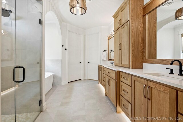 3406 W Quantico Pl, Broken Arrow, OK 74011 - bathroom with double vanity, a freestanding tub, a stall shower, and tile patterned flooring