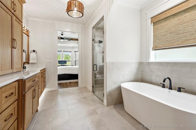 3406 W Quantico Pl, Broken Arrow, OK 74011 - bathroom with vanity, a shower stall, a freestanding tub, a ceiling fan, and crown molding