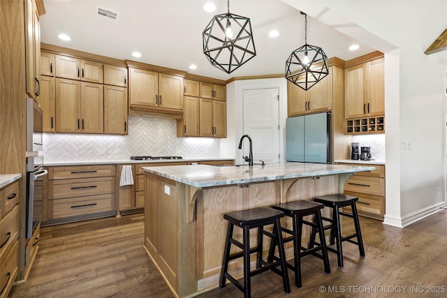 3406 W Quantico Pl, Broken Arrow, OK 74011 - kitchen with appliances with stainless steel finishes, a sink, decorative backsplash, recessed lighting, and a center island with sink