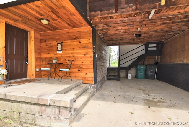 206 S Mounds St, Sapulpa, OK 74066 - interior space featuring unfinished concrete flooring, wood walls, and stairs