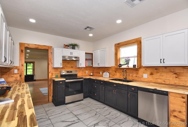 206 S Mounds St, Sapulpa, OK 74066 - kitchen featuring stainless steel appliances, a sink, under cabinet range hood, white cabinets, and dark cabinetry