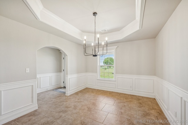 6200 E 340th Rd, Talala, OK 74080 - unfurnished room with a chandelier, arched walkways, a tray ceiling, a decorative wall, and wainscoting