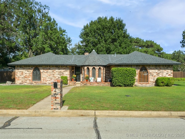 402 Beaumont Dr, Ardmore, OK 73401 - view of front of house with a shingled roof, brick siding, and a chimney