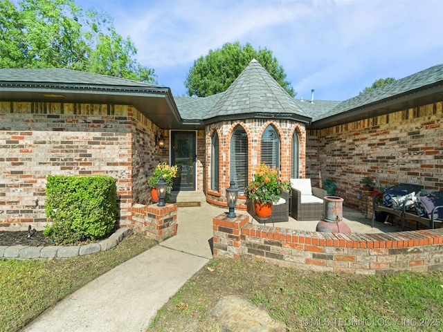 402 Beaumont Dr, Ardmore, OK 73401 - view of exterior entry featuring brick siding and a patio area