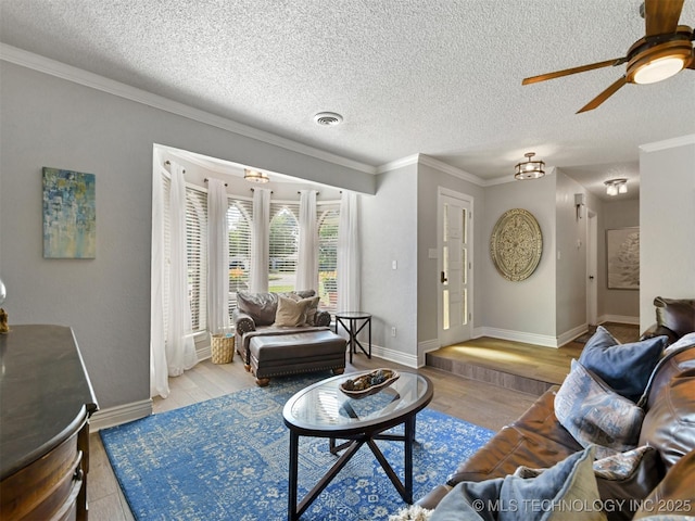 402 Beaumont Dr, Ardmore, OK 73401 - living area with ceiling fan, ornamental molding, baseboards, a textured ceiling, and wood finished floors