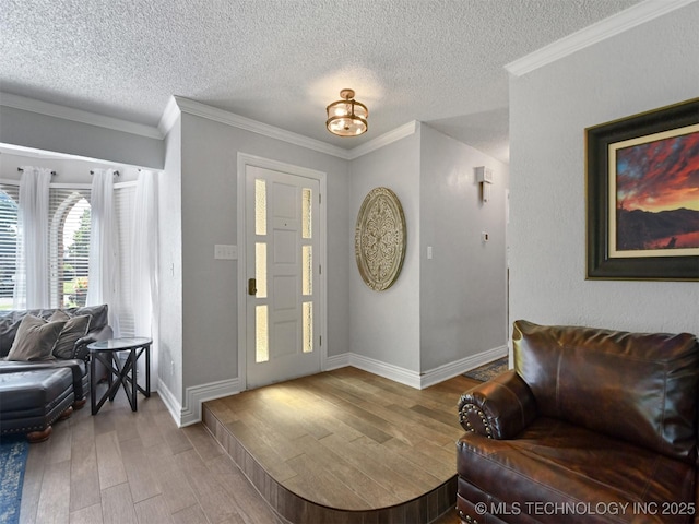 402 Beaumont Dr, Ardmore, OK 73401 - foyer entrance featuring wood finished floors, a textured ceiling, ornamental molding, and baseboards