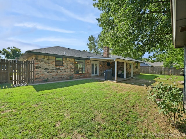 402 Beaumont Dr, Ardmore, OK 73401 - rear view of property with a chimney, a patio area, brick siding, and central AC