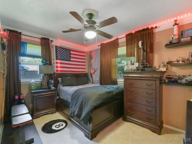 402 Beaumont Dr, Ardmore, OK 73401 - bedroom featuring multiple windows, a textured ceiling, ceiling fan, and carpet
