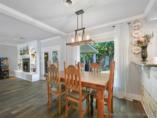 402 Beaumont Dr, Ardmore, OK 73401 - dining room featuring a warm lit fireplace, dark wood-type flooring, ornamental molding, a chandelier, and baseboards