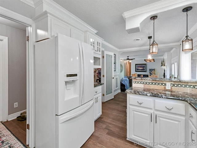 402 Beaumont Dr, Ardmore, OK 73401 - kitchen with white fridge with ice dispenser, white cabinets, dark wood-type flooring, glass insert cabinets, and a textured ceiling