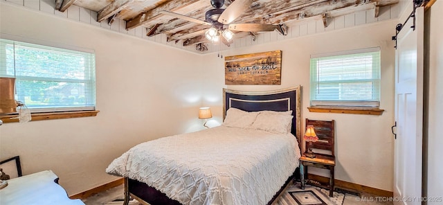 114276 S 4170th Rd, Checotah, OK 74426 - bedroom featuring multiple windows, baseboards, a barn door, ceiling fan, and beam ceiling