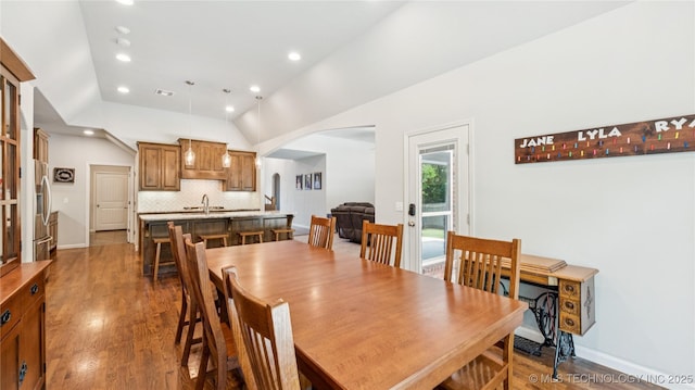 11602 S 30th W Ave, Jenks, OK 74037 - dining room with arched walkways, wood finished floors, recessed lighting, lofted ceiling, and baseboards