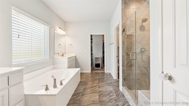 11602 S 30th W Ave, Jenks, OK 74037 - full bathroom featuring marble tiled flooring, vanity, a shower stall, a garden tub, and a walk in closet